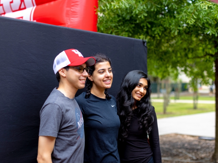 three students posing at event