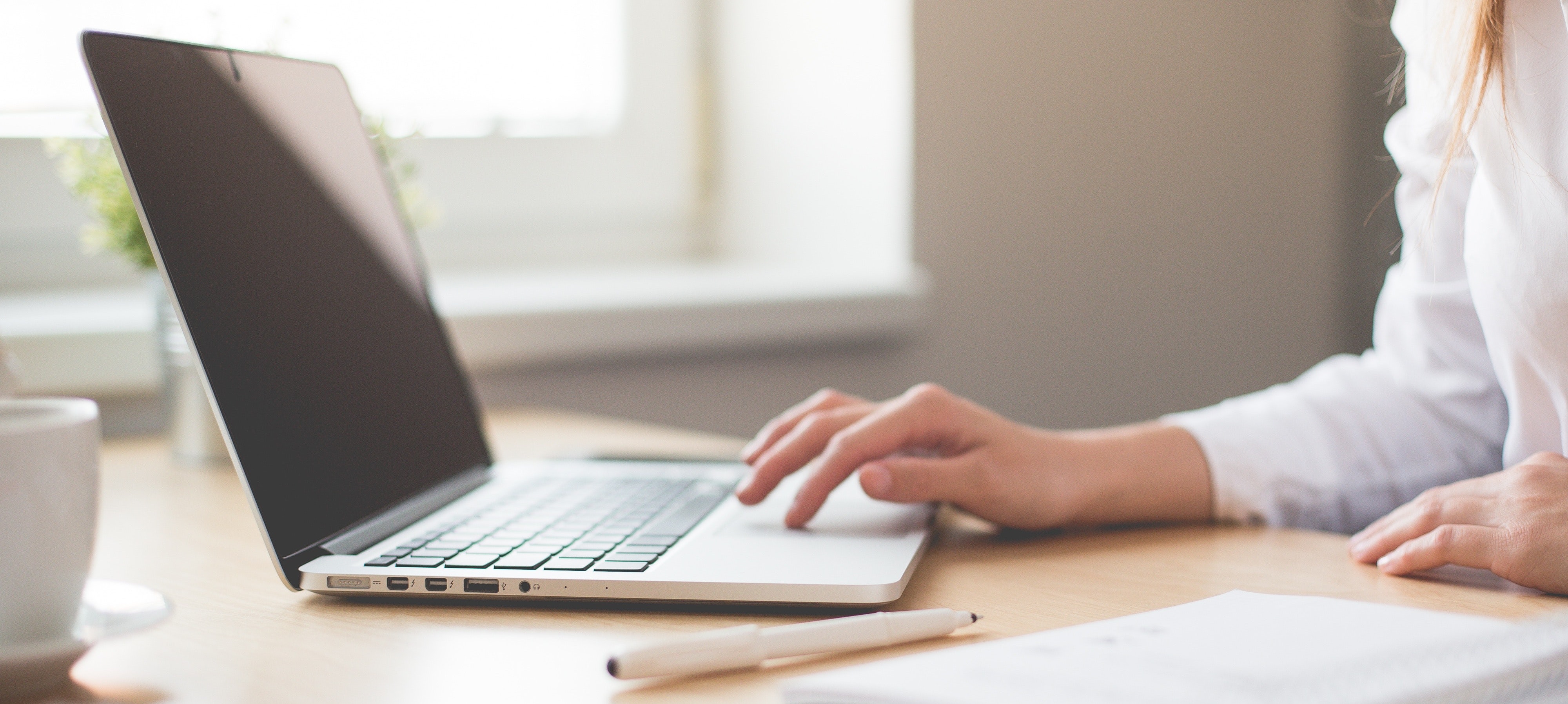 Woman types on laptop computer