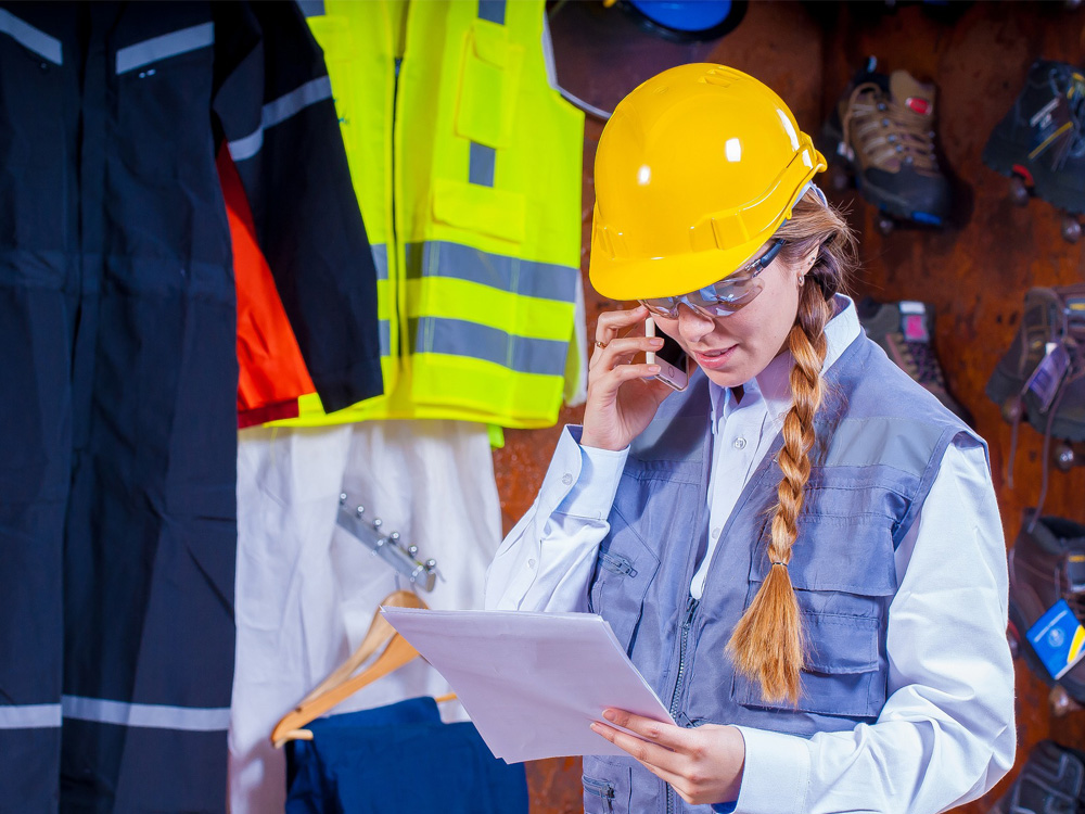 A female front line worker wearing a yellow hard hat