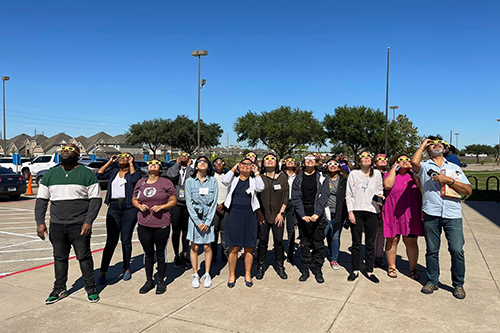 Group of students looking at the eclipse