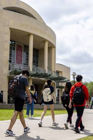 student walking on UH campus