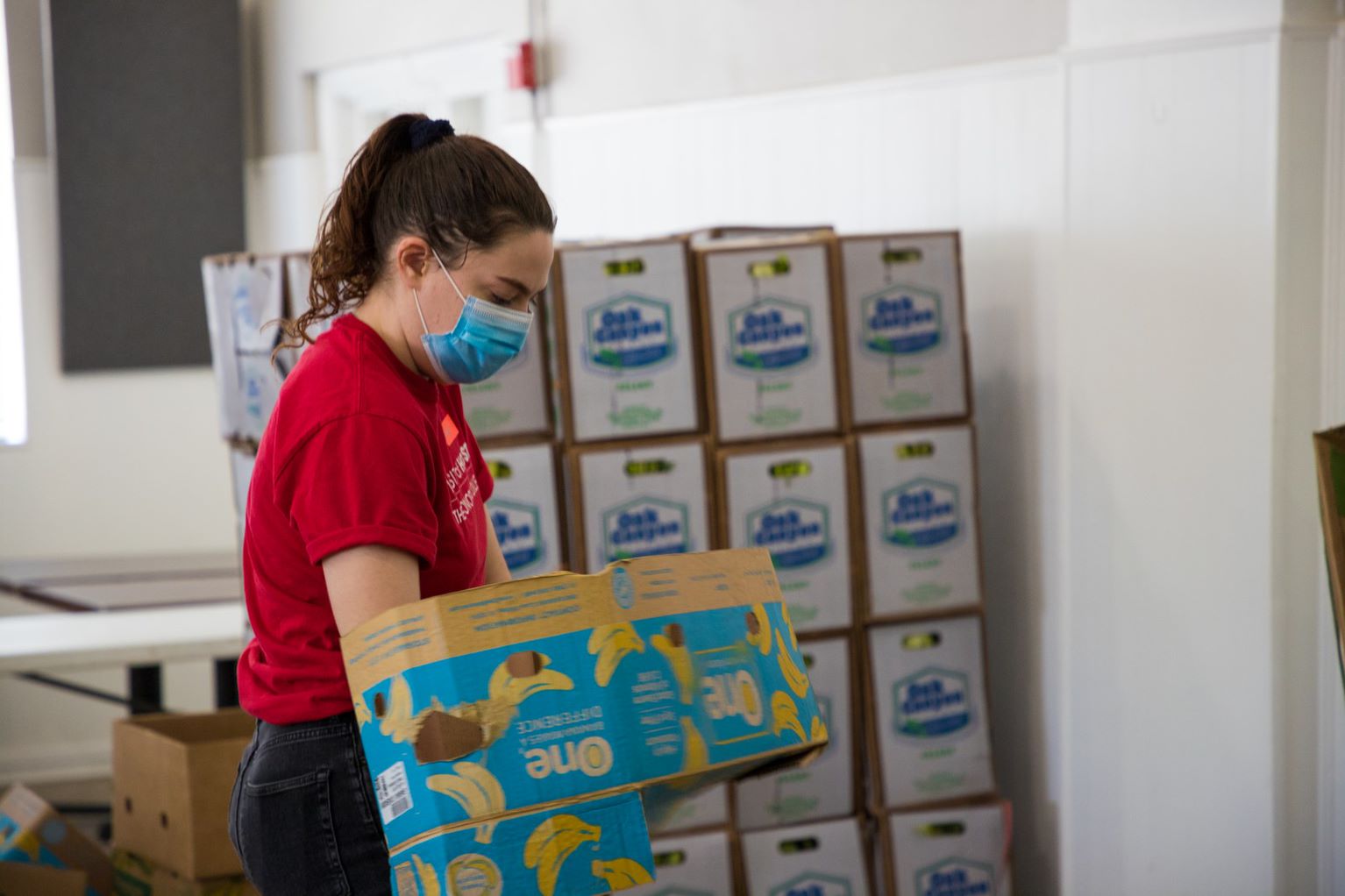 student unpacking food at pantry