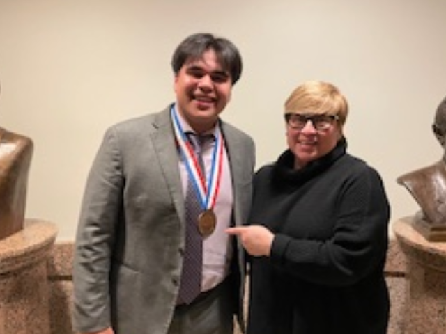 student with winning medal