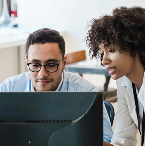 2 people looking at a computer screen