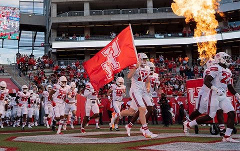 UH Football team rushing the field