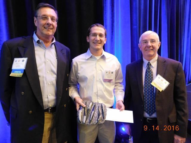 Master's student Andrew Steier receives first place poster award from Houston Geological Society president John Jordan and president-elect John Adamick.