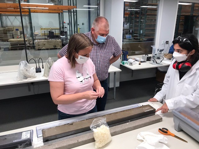 Elaine Mawby of the British Antarctic Survey and Asmara Lehrmann, a Univ. of Alabama graduate student now studying at UH, examine an Antarctic sediment core in 2021