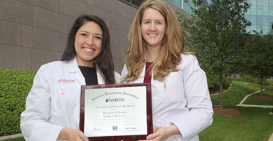 photo of najera and underwood with plaque