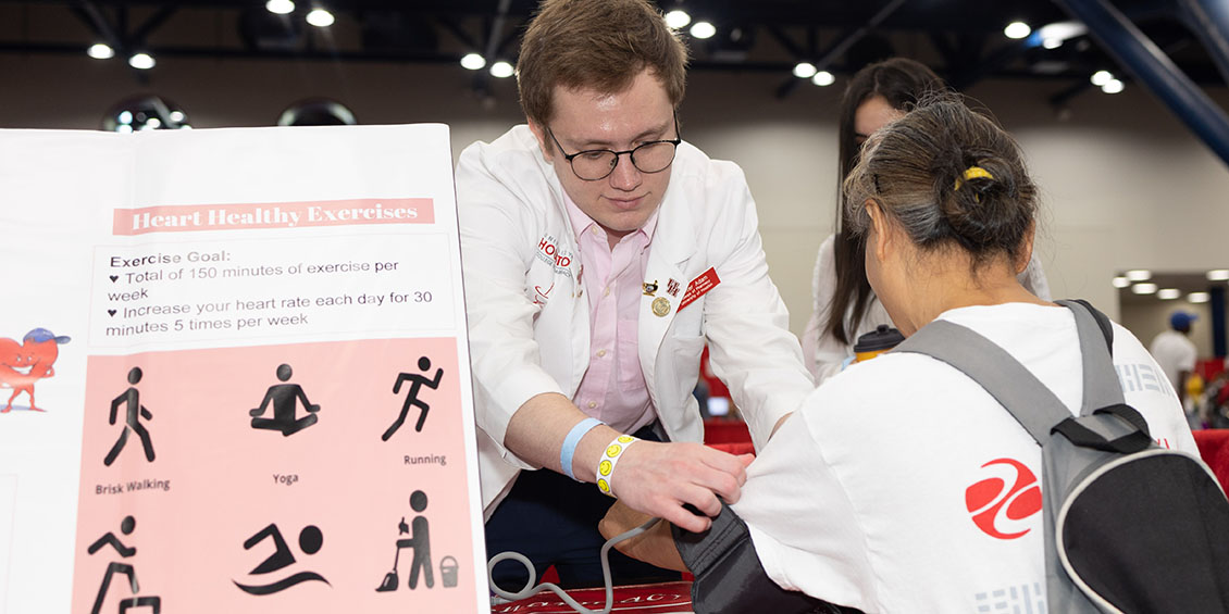 Student Hunter Adam from HPSA takes the blood pressure of a patient.