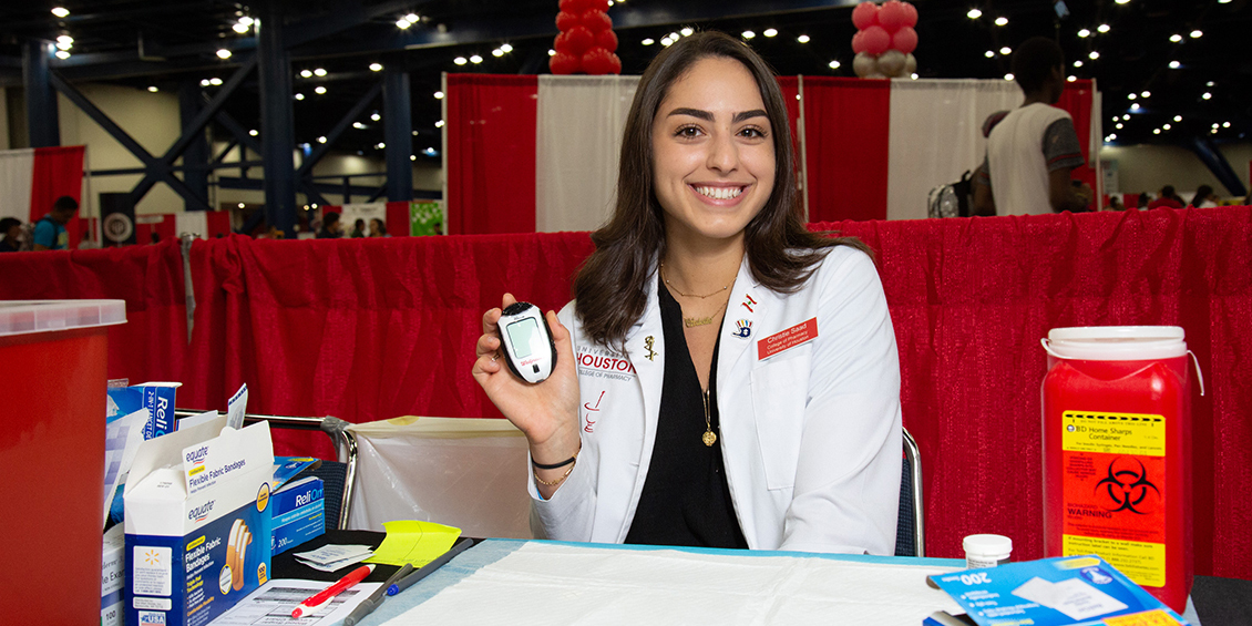 Student showcases diabetic blood testing equipment.