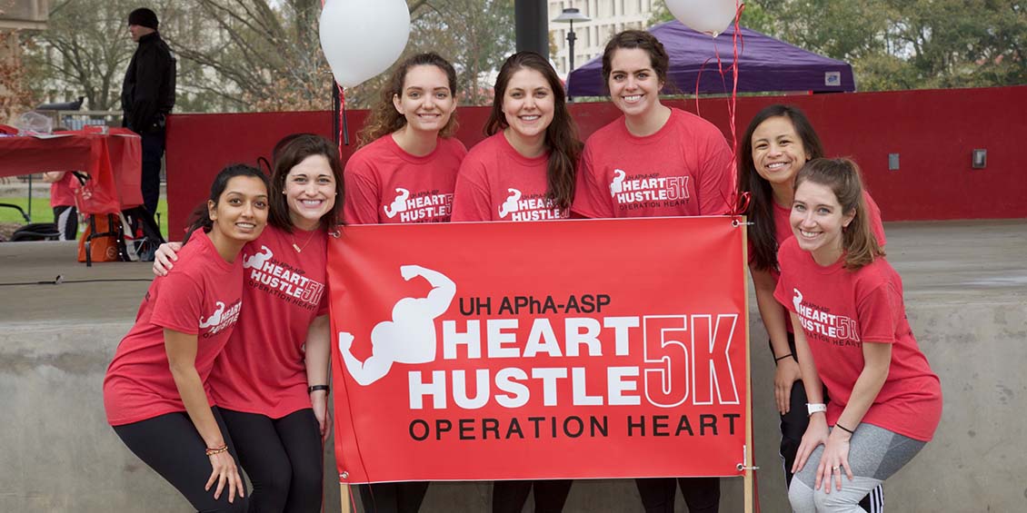 photo of students with event banner