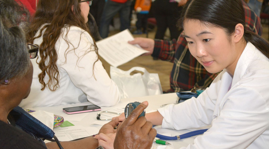 photo of student doing blood pressure measurement