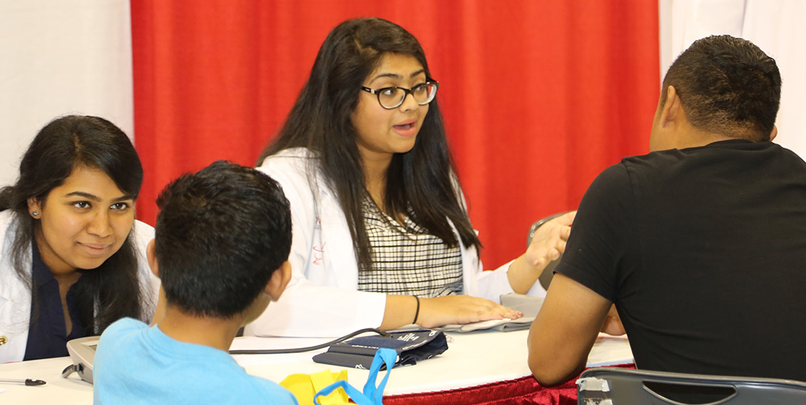 photo of students interacting with adult and child