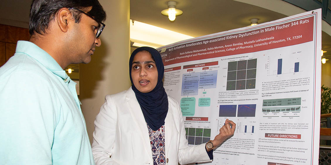 student discusses research poster