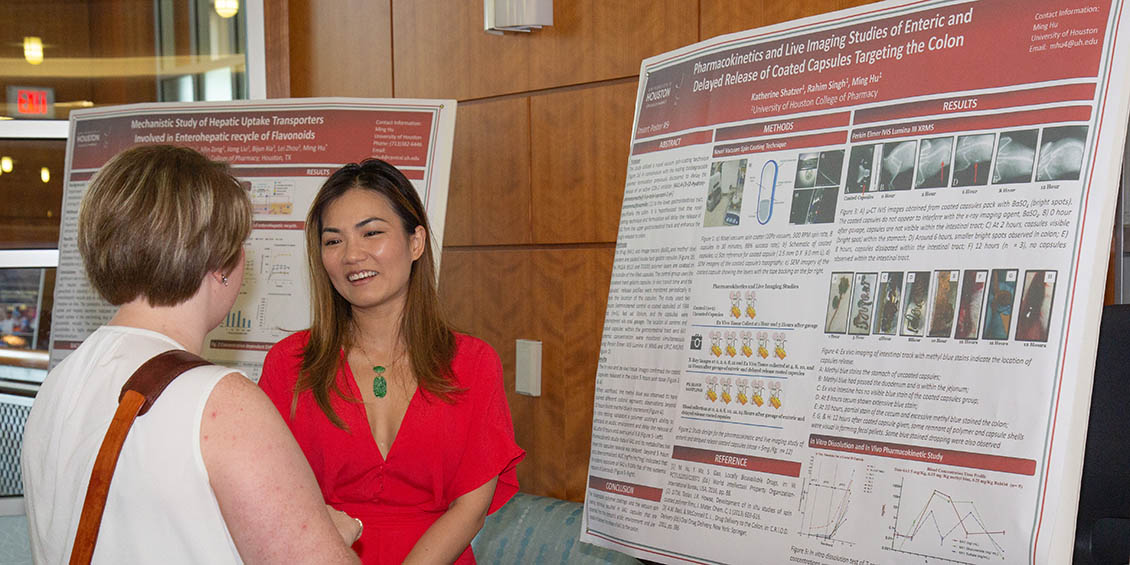 student discusses research poster