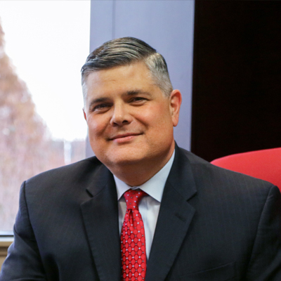 A man in a suit sitting at a desk