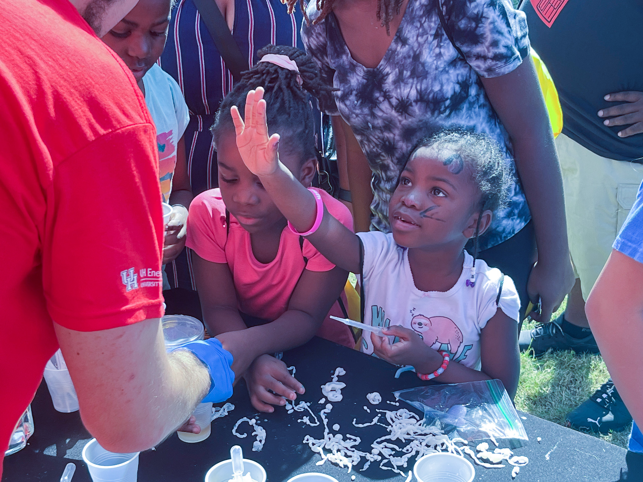 Participants gather to observe demonstration at Energy Day festival